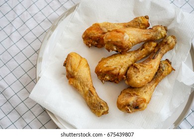 Selective Focus Of Home Made Deep Fired Chicken Drumstick On White Tissue To Soak Up Oil, Thai Food                                                            