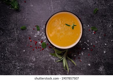 Selective Focus. Homemade Beef Bone Broth In A Deep Soup Bowl. On A Dark Background. With The Addition Of Spices-salt And Pepper. Bones Contain Collagen, Which Provides The Body With Amino Acids