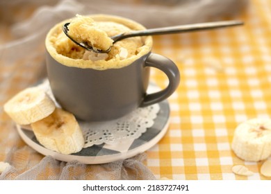 Selective Focus. Homemade Portioned Banana Bread Mugcake In Small Mugs. Easy Sweet Baking In The Microwave Idea, With Fresh Bananas, Nuts. Muffin With Banana Slices Cooked In A Mug. Copy Space. 