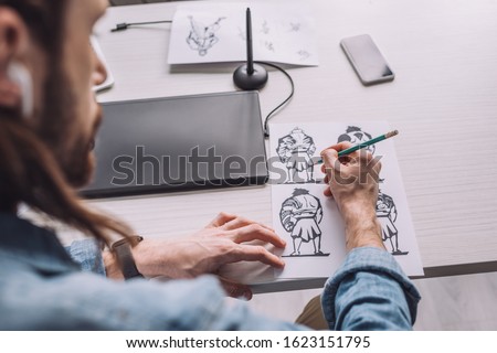 selective focus of illustrator drawing cartoon sketches