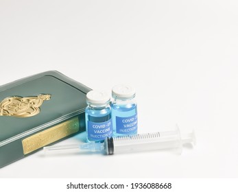 Selective Focus Image Covid 19 Vaccines,syringe,Holy Quran With Arabic Calligraphy Means Koran. Halal Status Of The Vaccine Shots Concept.