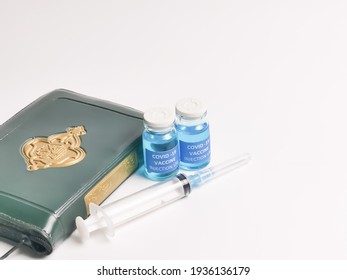 Selective Focus Image Covid 19 Vaccines,syringe,Holy Quran With Arabic Calligraphy Means Koran. Halal Status Of The Vaccine Shots Concept.