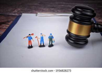 Selective focus image of gavel with miniature of labor. Labor law concept.  - Shutterstock ID 1936828273