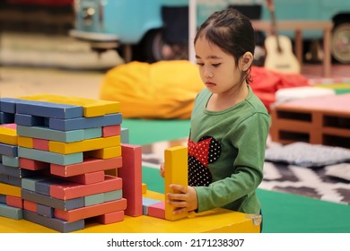 Selective Focus Image Of Little Asian Girl Play With Colorful Building Block.