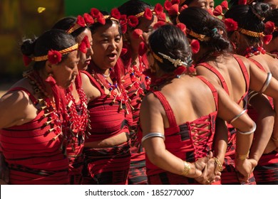 Selective focus image of Naga women dancing wearing their traditional ethnic attire in Kisama heritage village in Nagaland India during hornbill festival on 4 December 2016