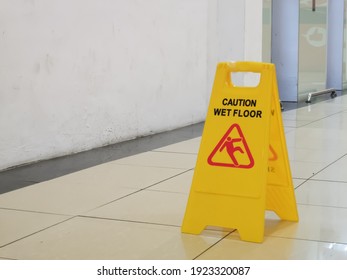 Selective Focus Image With Noise Effect Shopping Mall Interior With Wet Floor Caution Sign.