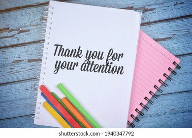 Selective Focus Image Note Book And Colorful Wooden Stick With Thank You For Your Attention Wording On A Wooden Background And Flare Effect. Conceptual Image