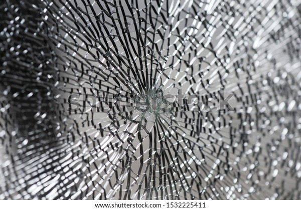 Selective focus image on Broken car\
windshield. Accident of car. Closeup of broken glass\
texture.