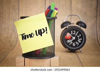 Selective focus image of Time Up wording on a blur background of alarm clock