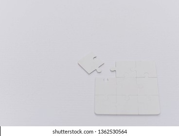 Selective focus image of white jigsaw puzzle pieces. - Shutterstock ID 1362530564
