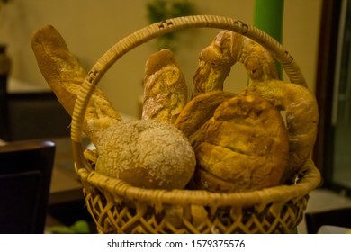 Selective focus images of assorted breads put on the traditional bamboo basket.