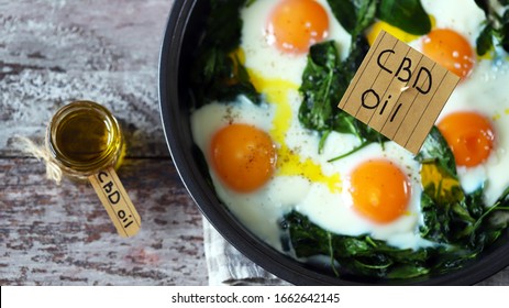 Selective Focus. The Inscription Cbd Oil In Food. Spinach Eggs With Cannabis Oil. CBD Use Of Oil Concept.