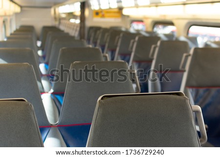 Selective focus. Interior of a passenger train with empty seats.