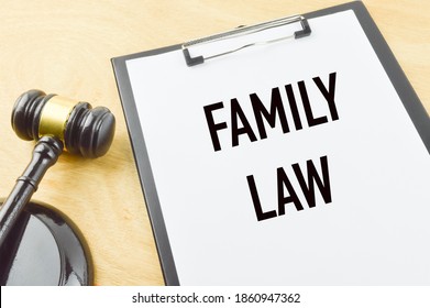 Selective focus of judge gavel and paper holding file written with text FAMILY LAW over wooden background. 