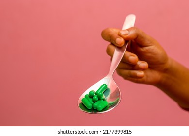 Selective Focus Of A Lady Holding Spoon With Medicines. 