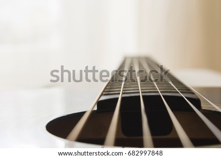 Selective focus, macro lens, shooting retro classic vintage guitar, focus on strings.