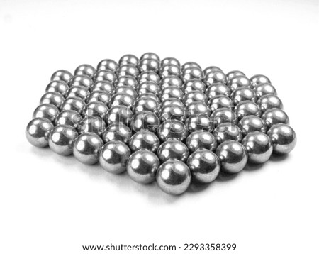selective focus lot of magnetic metal balls on white background.