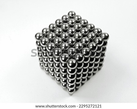 selective focus lot of magnetic metal balls  square shape on white background.
