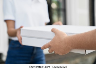 Selective Focus Of Male Hands Giving Two Boxes Of Pizza To Woman. Close Up Of Incognito Female In Casual Outfit Receiving Order From Deliveryman Outdoors. Food Delivery Concept.