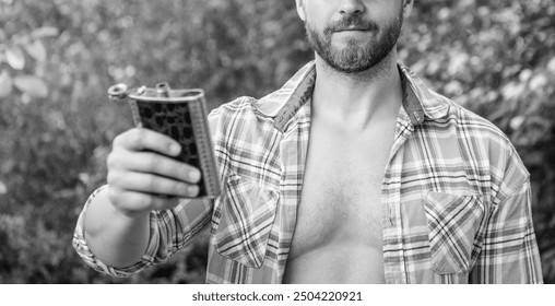 selective focus of man with bourbon hipflask outdoor. man with bourbon hipflask