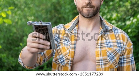 selective focus of man with bourbon hipflask outdoor. man with bourbon hipflask