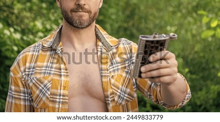 selective focus of man with bourbon hipflask outdoor. man with bourbon hipflask