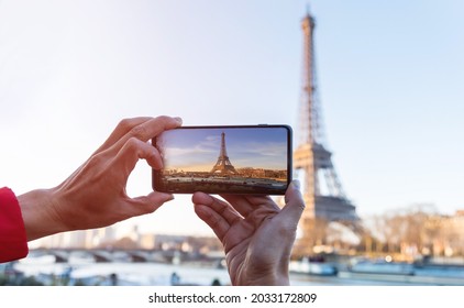  Selective focus of man hand with he is using smartphone take photo at View on Eiffel Tower, Paris, France