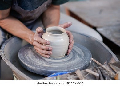 Selective focus of man hands working on pottery wheel at workshop. Image contains certain grain or noise and soft focus. - Powered by Shutterstock