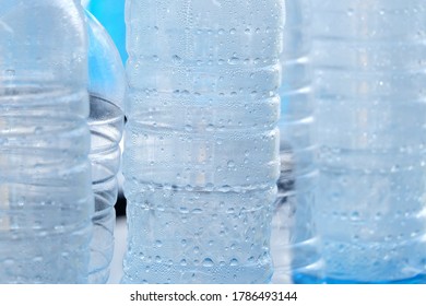In selective focus many drinking water drolets in a plastic bottle