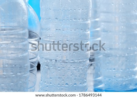 In selective focus many drinking water drolets in a plastic bottle
