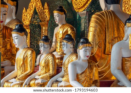 Selective focus. Many statues of sitting Buddha in different sizes at the Shwedagon Pagoda, Shwedagon Pagoda - Myanmar's most sacred Buddhist pagoda
