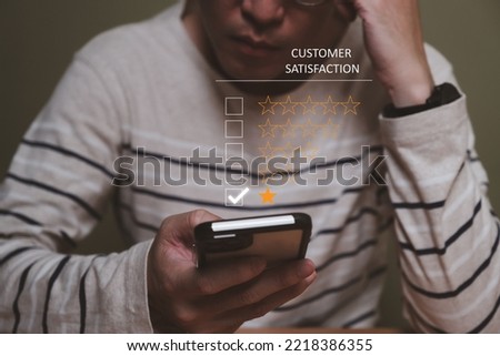 Selective focus at men hand while type on smartphone to give customer satisfaction feedback for poor service quality that need meet expectation or standard of the service. Bad experience feedback.