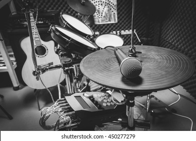 selective focus the  microphone and music instruments the guitar,electric drum,speakers background. 
