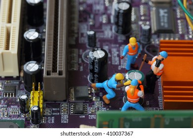 Selective focus of miniature engineer and worker fixed, mainboard computer and use for business background. - Powered by Shutterstock