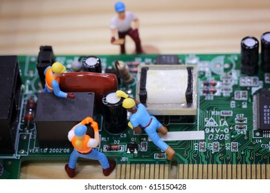 Selective focus of miniature engineer, worker fixed and maintenance mainboard computer.