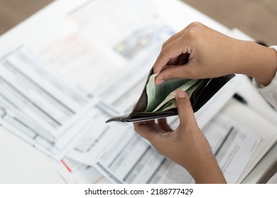 Selective Focus At Money Wallet Woman Opening Less Bank Note On Payday. Broke Person Has Few Cash Money In Purse To Pay Bill Statement Or Spending. Inflation Crisis Concept Need Of Spending.