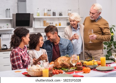 Selective Focus Of Multicultural Family Celebrating Thanksgiving Near Food On Table