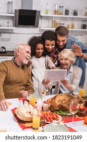 Selective Focus Of Multiethnic Family Having Video Chat On Digital Tablet Near Turkey During Thanksgiving