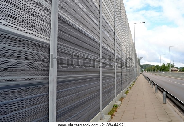Selective focus of noise barrier, which is an\
outdoor structure designed to protect people from noise, against\
the background of blurred road\
traffic.