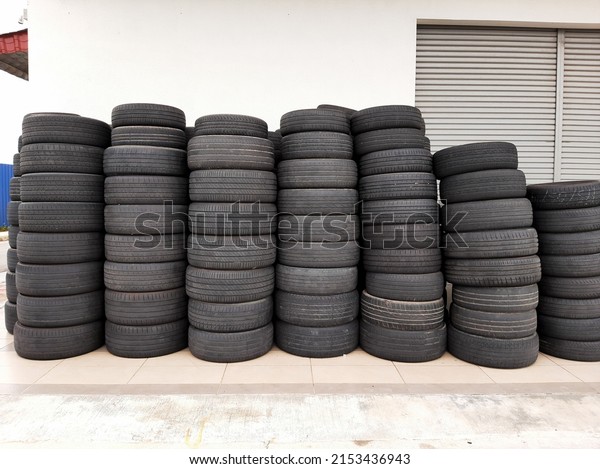 Selective focus with noise effect\
added picture of used tyre been stacked outside of the\
shop.