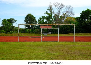 Selective focus and noise effect picture of rusty goalpost still used in the football field that can cause hazard to player