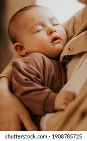 selective focus, noise effect: Young mother holding her newborn child. mother's care baby. Woman and newborn girl relax. Baby sleeping on mom's arms