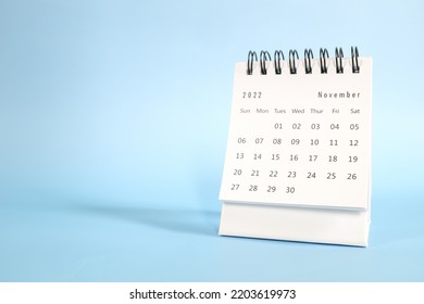 Selective focus of November 2022 desk calendar on blue background with copy space. - Shutterstock ID 2203619973