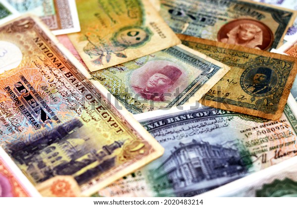 Selective focus of old Egyptian pounds and piasters money banknotes background at the time of the Kingdom of Egypt and Sudan with an Image of king Farouk I, King Tutankhamen and Egyptian landmarks
