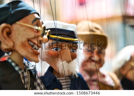 Selective focus of old sailor Puppets hanging at the souvenir store. Prague. Souvenir puppets (Marionettes)
