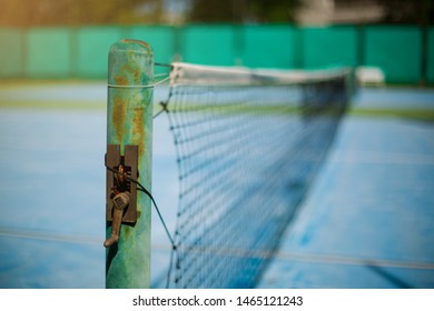 Selective Focus To Old Tennis Net With Blurry Green Background. Tennis Game. Sport, Recreation Concept.