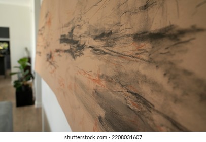 Selective Focus On An Abstract Painting Drawn In Manila Paper, Hanging From The Wall.