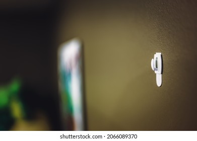 Selective focus on adhesive strip wall hanger that can be removed by pulling tape
