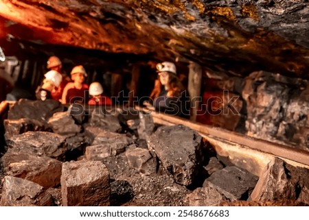 Selective focus on anthracite coal on a hopper with defocused group in the Lackawanna Coal Mine Tour at McDade Park. High quality photo