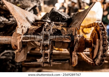 Selective focus on anthracite coal on a conveyer belt with defocused group in the Lackawanna Coal Mine Tour at McDade Park.